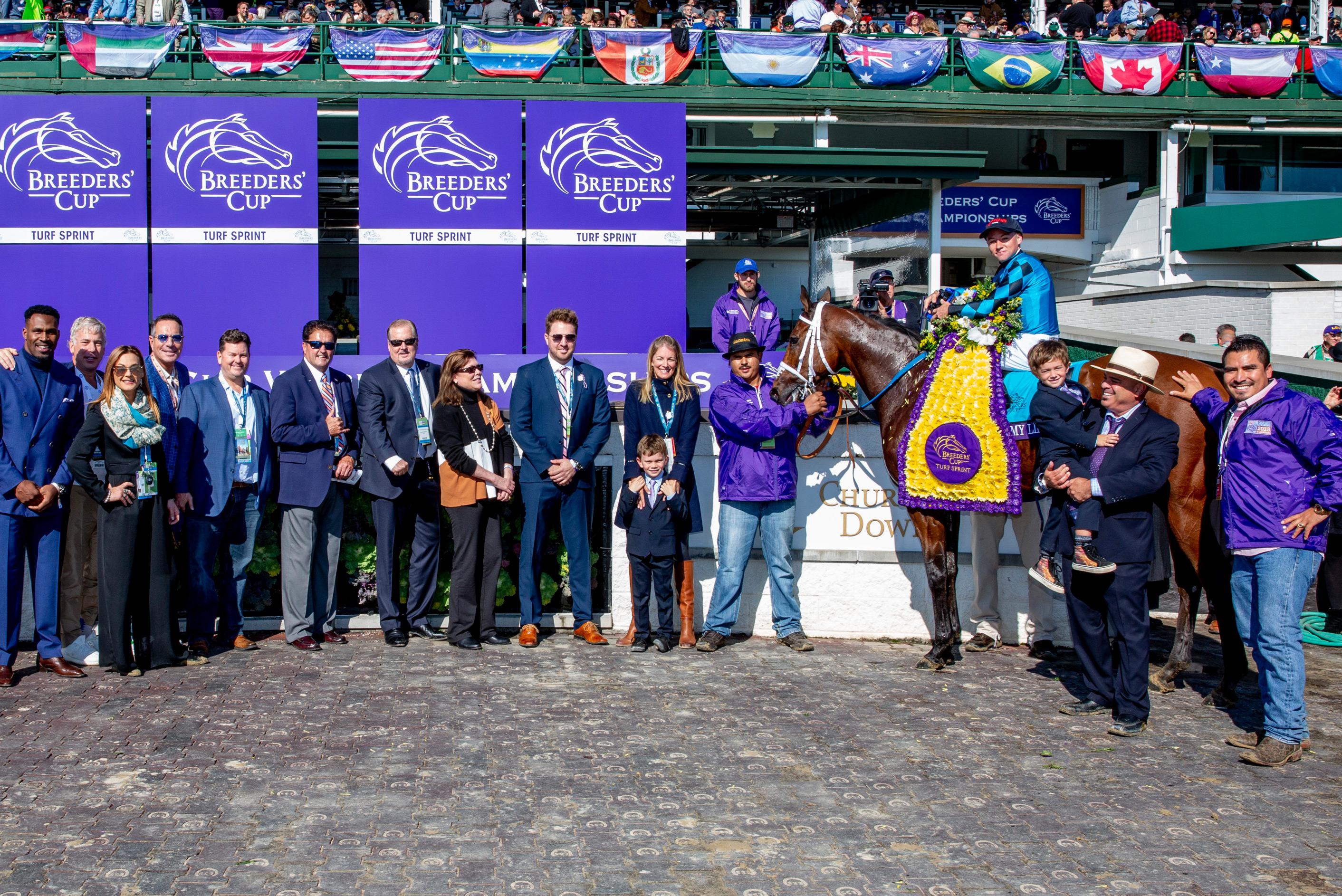Stormy Liberal, Trump, and others in the 2018 Turf Sprint winner's circle. (Eclipse Sportswire) Stormy Liberal, Trump, and others in the 2018 Turf Sprint winner's circle.
