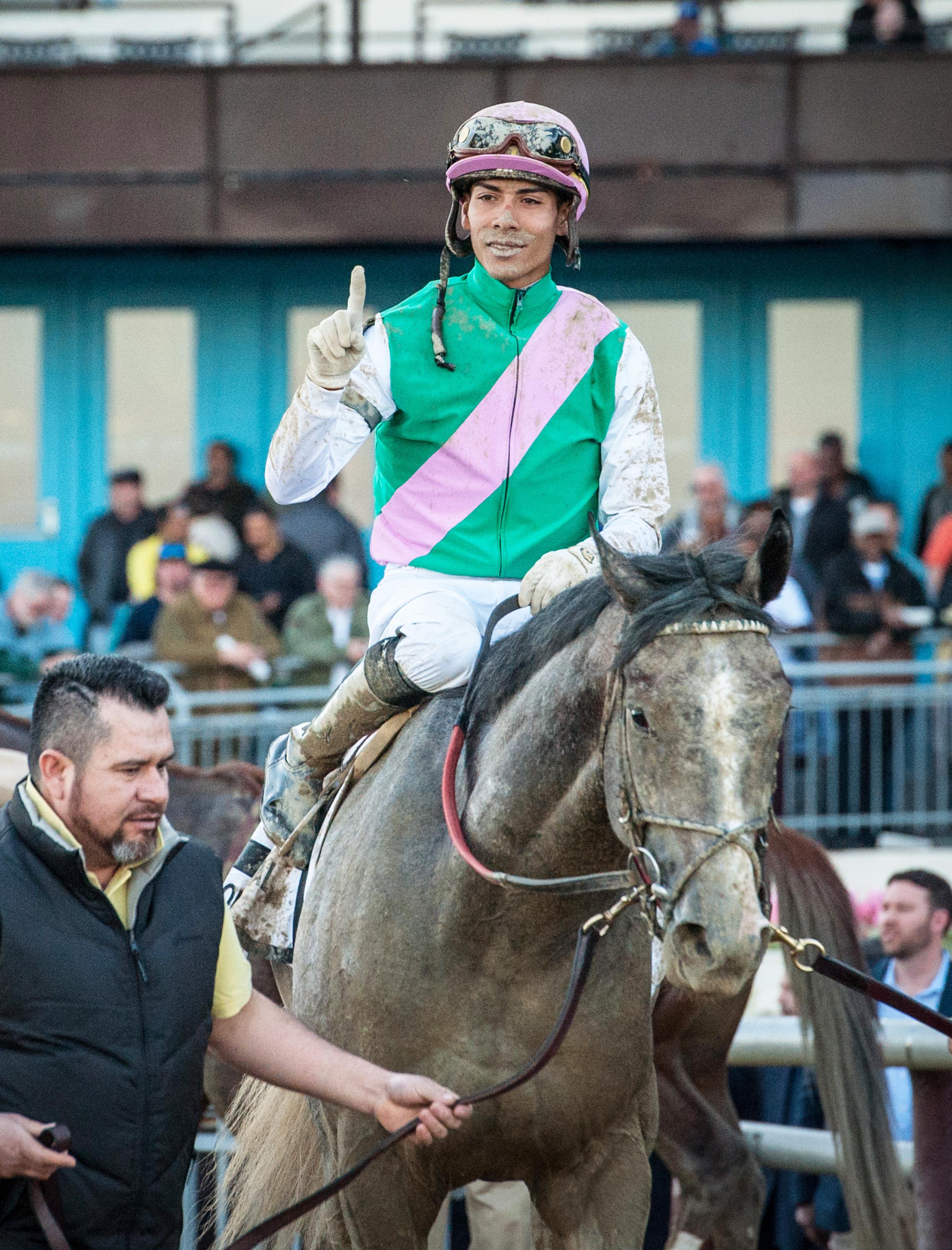 Tacitus and Ortiz enter the Aqueduct winner's circle.